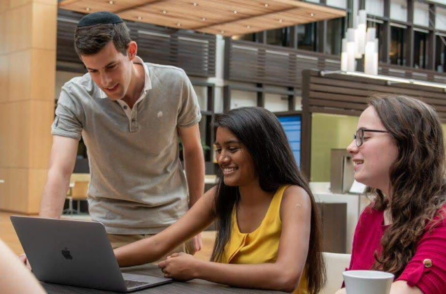 Jeyashree with two other people looking at a computer